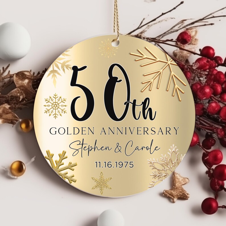 May include: Gold round ornament with a gold background and snowflakes. The ornament says "50th Golden Anniversary Stephen & Carole 11.16.1975"