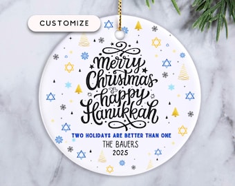 May include: White ceramic Christmas ornament with gold string. The ornament features the text "merry Christmas & happy Hanukkah" in black script, with blue and gold accents. The text "TWO HOLIDAYS ARE BETTER THAN ONE" is also included.