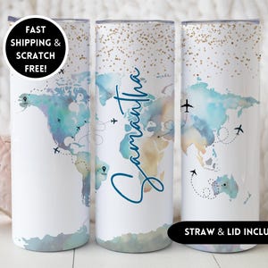 May include: White travel tumbler with a world map design in shades of blue and tan. The tumbler features the name "Samantha" in a script font. Airplanes and dotted lines trace flight paths across the map. The text "STRAW & LID INCLUDED" is also visible.