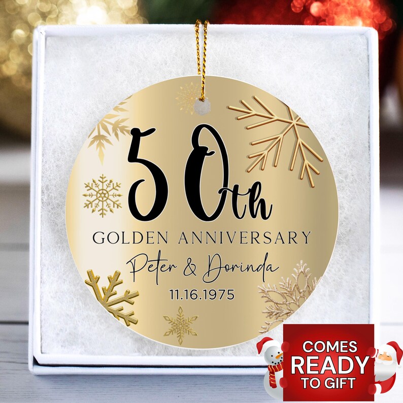 May include: Gold Christmas ornament with a gold background and snowflakes. The ornament says "50th Golden Anniversary Peter & Dorinda 11.16.1975"