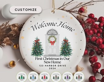 May include: A white ceramic Christmas ornament with the text "Welcome Home" and "First Christmas in Our New Home." The ornament features a door with a wreath and two Christmas trees. The address "123 HARBOR DRIVE 2024" is also displayed. The word "CUSTOMIZE" is at the top.