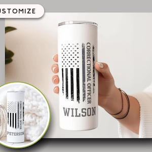 May include: A white stainless steel tumbler featuring a distressed American flag design. The tumbler includes the text "CORRECTIONAL OFFICER" and a personalized name. The tumbler is BPA-free and suitable for hot and cold beverages.