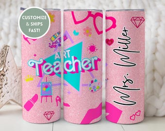 Può includere: Un bicchiere rosa glitterato con le parole "ART Teacher" e "Mrs. Miller" in corsivo. Il bicchiere presenta grafiche legate all'arte come tavolozze, rossetti e diamanti. Il design è in rosa, verde acqua e magenta.