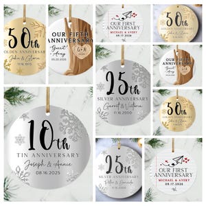 May include: A set of ten round, silver and gold ornaments with snowflake designs and anniversary text. The ornaments feature different anniversary milestones, including 10th, 25th, 50th, and first anniversaries. Each ornament has a personalized message with the couple's names and the date of their anniversary.