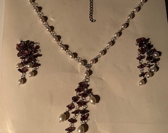 Sehr ausgefallene Garnitur bestehend aus einer Kette und ein paar Ohrringen in 925 Sterling Silber. Süßwasser Perlen und Granat