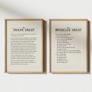May include: Two framed prints with text. The left print reads "The Nicene Creed" and the right print reads "The Apostles' Creed". The text is in black on a cream-colored background, with a simple wooden frame.