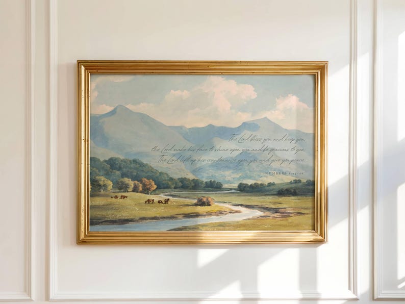 A printable wall art listing with a vintage oil painting in blues, greens, and yellows with a mountainous blue landscape, green trees, and a river running through a meadow with the bible verse from Numbers 6:24-26: "The Lord bless you and keep you; the Lord make his face to shine upon you and be gracious to you; the Lord lift up his countenance upon you and give you peace" written in script over the landscape. The scripture makes this subtle Christian art.