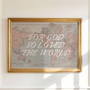 May include: Framed world map print with the text "FOR GOD SO LOVED THE WORLD" in white script. The map has a vintage aesthetic with muted colors and is encased in a gold frame.