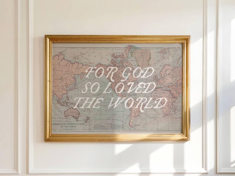 May include: Framed world map print with the text "FOR GOD SO LOVED THE WORLD" in white script. The map has a vintage aesthetic with muted colors and is encased in a gold frame.