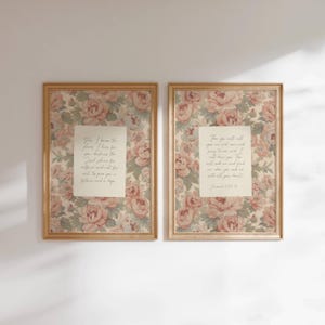 May include: Two framed floral prints with a vintage aesthetic. Each features a cream-coloured centre with script text, surrounded by a rose and green floral pattern. The frames are a light wood colour, adding to the classic design.