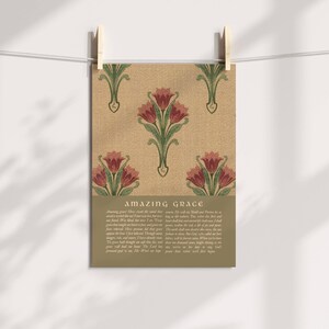 May include: A rectangular wall art print featuring a repeating pattern of red tulips with green stems on a textured tan background. Below the floral design, the text "AMAZING GRACE" is printed in a bold font, followed by the full lyrics of the hymn.