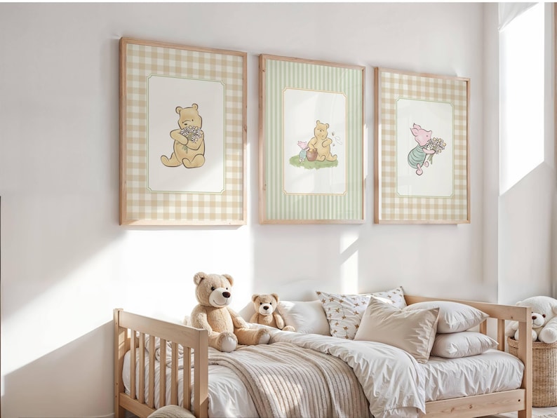 Set of 3 Nursery Wall Art Prints. Each is matted on top of orange gingham (left and right frame) and green and beige stripes (middle frame). Each has its own vintage winnie the pooh illustration. The first image has winnie the pooh holding a bouquet of wildflowers tightly. The second has Pooh and Piglet sitting together enjoying eating hunny. The right image has piglet walking along carrying a bunch of wildflowers. They look preppy, vintage, antique, classic style.