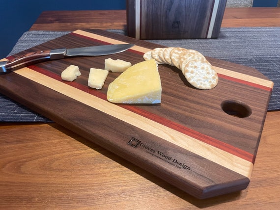 Customizable Charcuterie or Cutting Board handcrafted from Walnut, Padauk, and Maple hardwoods.