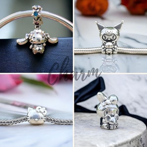 May include: Four silver charm bracelets with different Sanrio character charms. The charms include Hello Kitty, My Melody, Little Twin Stars, and Cinnamoroll.