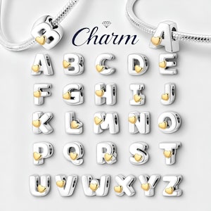 May include: Silver alphabet charms with gold heart accents. Each letter of the alphabet is represented, with a small gold heart detail. The word "Charm" is written in cursive above the letters. These charms are designed to be added to a bracelet.