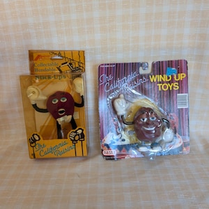 1980&#39;s California Raisins Stick-Up and Wind-up Figurines in Original Packaging