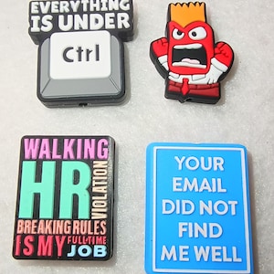 May include: A white ceramic mug with a black handle and the text "But First, Coffee" in a bold, black font. The mug is filled with a dark liquid, likely coffee, and sits on a light-colored surface.