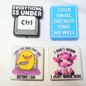 May include: Four rectangular shoe charms. Top left: black and white keyboard key with text EVERYTHING IS UNDER Ctrl. Top right: blue rectangle with text YOUR EMAIL DID NOT FIND ME WELL. Bottom left: yellow duck with a knife on a laptop. Bottom right: pink cow with headphones.