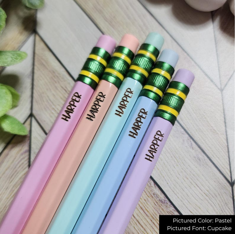 May include: Five pastel-coloured pencils, each inscribed with the name "HARPER". The pencils feature green and yellow detailing near the eraser. The colours include pink, peach, blue, and lavender.