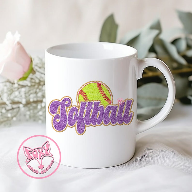 May include: White ceramic mug with a purple and gold glitter design that says "Softball" with a yellow softball graphic.