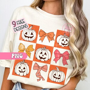 May include: Cream-colored t-shirt featuring a grid pattern with orange squares. The squares display jack-o'-lanterns and bows in shades of orange and pink. Text on the shirt reads "9 FREE DESIGNS" and "PNG".