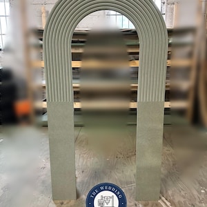 May include: A large, pale green archway with a curved top and vertical lines. The arch is supported by two rectangular columns. The logo for "The Wedding CNC Co." is visible in the lower right corner.