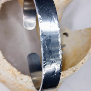 Lightly hand stamped footprints in the sand bracelet