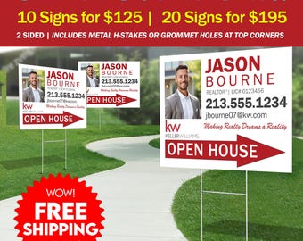 May include: White rectangular real estate signs featuring a portrait of a person in a suit, the name Jason Bourne, contact information, the Keller Williams logo, and a red arrow pointing right with the text Open House, supported by metal H-stakes.