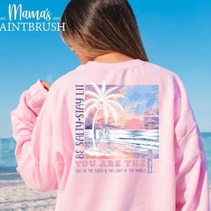 This “Be Salty, Stay Lit” Christian PNG design inspired by Matthew 5:13–16 features a peaceful tropical sunset, palm trees, ocean waves, and a cross—symbolizing faith, light, and God’s calling for believers to shine in the world. With its soft pastel coastal colors and uplifting Bible verse message, this digital download is perfect for creating faith-based apparel, gifts, and home décor.