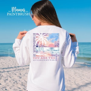 This “Be Salty, Stay Lit” Christian PNG design inspired by Matthew 5:13–16 features a peaceful tropical sunset, palm trees, ocean waves, and a cross—symbolizing faith, light, and God’s calling for believers to shine in the world. With its soft pastel coastal colors and uplifting Bible verse message, this digital download is perfect for creating faith-based apparel, gifts, and home décor.