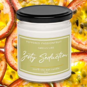 May include: A white 9 oz soy wax candle with a black lid. The label reads "Peppered Passionfruit Smells Like Zesty Seduction." The background features passion fruit slices, with yellow and orange hues.