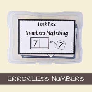 May include: A clear plastic storage box containing educational materials with a label that reads Task Box: Numbers Matching, featuring a graphic of the number 7 being placed into a box, with the text ERRORLESS NUMBERS below the container.