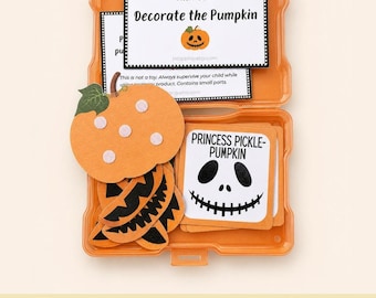 May include: An orange plastic storage case containing a pumpkin decorating activity set. It includes a felt pumpkin cutout with velcro dots, several black felt jack-o'-lantern face pieces, and white cards with text like Task Box: Decorate the Pumpkin.
