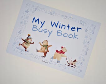 May include: A rectangular activity sheet titled My Winter Busy Book with blue text and a border of snowflakes. The illustration features three bears ice skating and one bear pulling a sled with a rabbit and a dog. The text Print ~ Cut ~ Play is below.