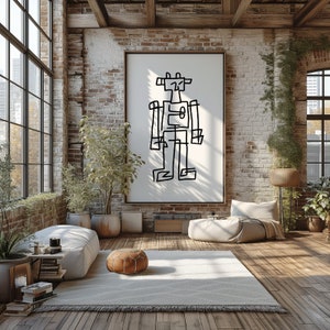 Pode incluir: Um desenho a preto e branco de um robô numa tela branca numa moldura preta pendurada numa parede de tijolo numa sala de estar de estilo loft. O robô está de pé no centro da tela. A sala tem uma janela grande, um piso de madeira e um sofá com almofadas.