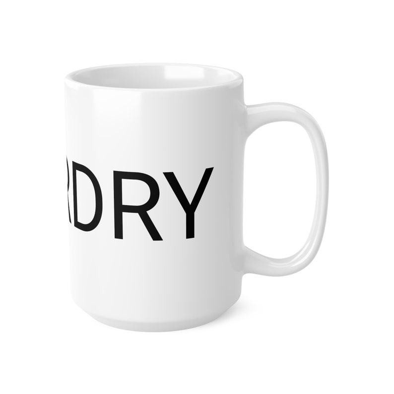 May include: A white ceramic coffee mug with a black uppercase DRY text. The mug has a large C-shaped handle. The mug is shown against a white background.