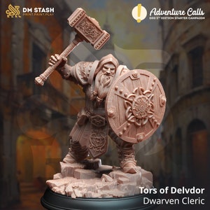 May include: A brown plastic miniature figurine of a dwarven cleric holding a hammer and shield. The figurine is standing on a rocky base. The text "Tors of Delvdor" and "Dwarven Cleric" is printed below the figurine.