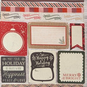 May include: A collection of Christmas-themed paper ephemera with various designs. Includes strips with text "HOME merry HOME", patterned borders, and cards with holiday messages like "Happy Holiday" and "Merry and Bright".