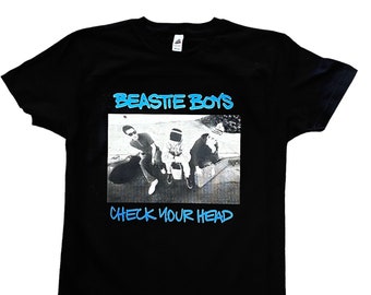 May include: Black t-shirt featuring a graphic of the Beastie Boys band members and the text "BEASTIE BOYS" and "CHECK YOUR HEAD" in blue.