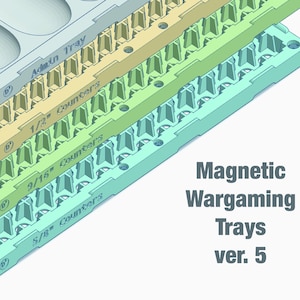 May include: A stack of four colorful magnetic wargaming trays in shades of blue, yellow, and green. Each tray is labeled with counter sizes, including 1/2", 9/16", and 5/8". The text "Magnetic Wargaming Trays ver. 5" is also visible.
