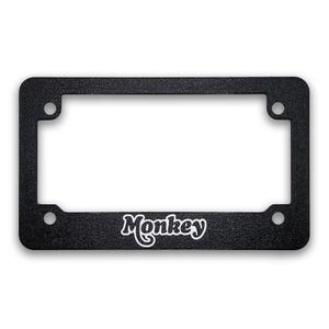 May include: Black license plate frame with the word "Monkey" in white script. The frame has a textured surface and four mounting holes, designed to fit a standard U.S. license plate.