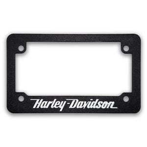 May include: Black license plate frame with the Harley-Davidson logo in white. The frame has a rectangular shape with rounded corners and four mounting holes. The text is in a bold, stylized font.