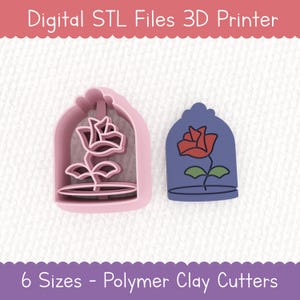May include: Pink and blue polymer clay cutters in the shape of a rose. One cutter is a pink outline of a rose in a bell jar, and the other is a pink outline of a rose. Text at the top reads "Digital STL Files 3D Printer". Text at the bottom reads "6 Sizes - Polymer Clay Cutters".
