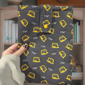 May include: A gray fabric pouch with a repeating pattern of yellow jelly molds and the text "Dammit Jim!"  The pouch has a flap with a button closure.