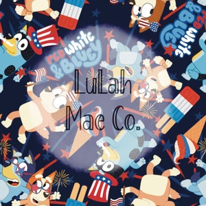 May include: A blue and brown cartoon dog wearing a red, white, and blue hat with stars. The dog is holding a red, white, and blue flag. The background is a dark blue with white stars and red, white, and blue fireworks. The text "Lulah Mae Co." is in the center of the image.