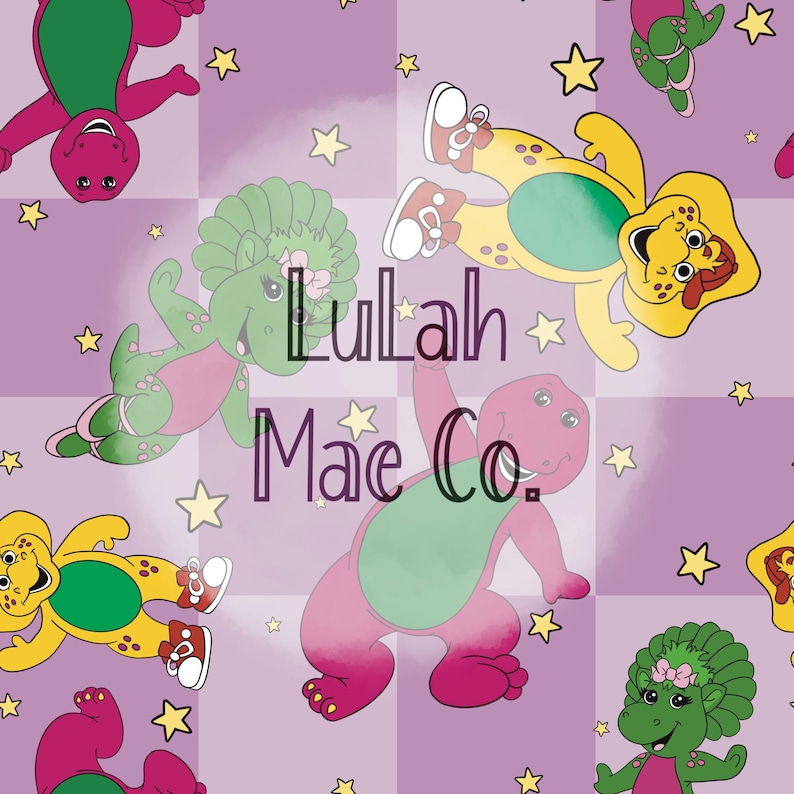 May include: A repeating pattern featuring cartoon dinosaurs in shades of purple, green, and yellow, with star accents. The text "Lulah Mae Co." is overlaid on the design. The dinosaurs are in various poses against a checkered background.