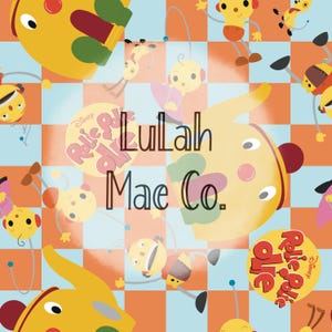 May include: A colorful fabric pattern featuring yellow, orange, and blue characters with a checkered background. The text "Roll-e-Polie Ollie" and "Lullah Mae Co." is visible in the center of the image.