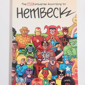 May include: A comic book cover featuring a colorful illustration of numerous Marvel superheroes. The title reads "The Marvel Universe According to Hembec". The characters include Iron Man, Spider-Man, and Captain America.
