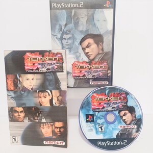 May include: Three items from the Tekken Tag Tournament video game for PlayStation 2. The items include a game case, a game box, and a game disc. The game case and box feature images of characters from the game. The disc has the game title and PlayStation 2 logo.