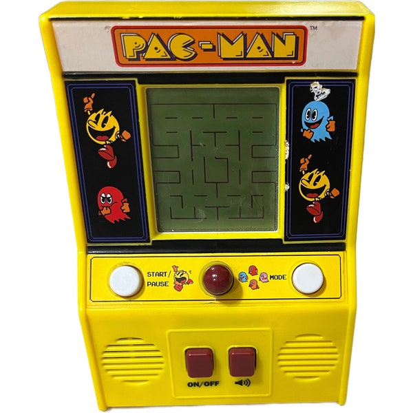 Retro handheld PAC-MAN game. Includes 2 AA batteries. Very good condition. Made by Bandai. Has 2 play modes- eat the dots and chase.